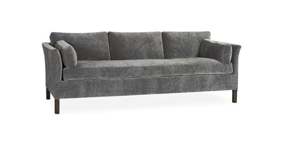 A gray couch with one long bottom cushions and wooden legs