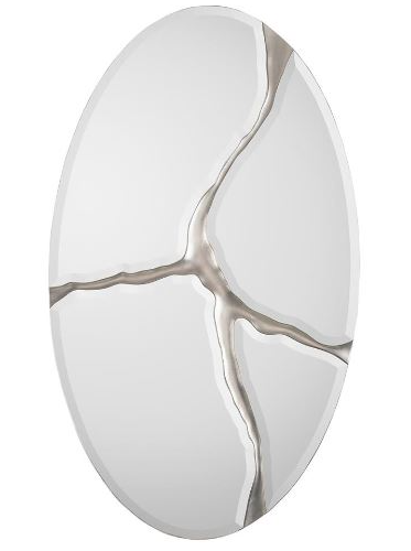 A white oval mirror with the appearance of being broken with a silver design.